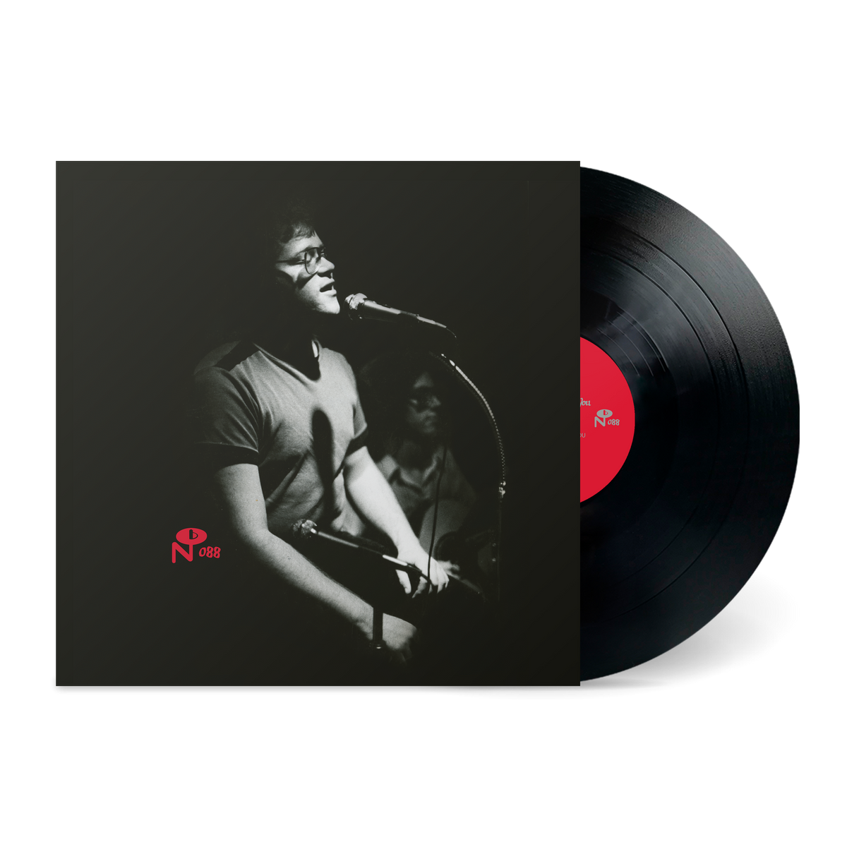 Black and white photo of a man singing at a microphone on the vinyl record "I Just Want To Talk To You