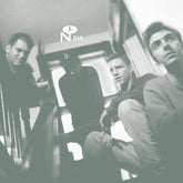 Black and white photo of four men sitting on stairs with logo, for Complete Studio Recordings by Numero Group Records
