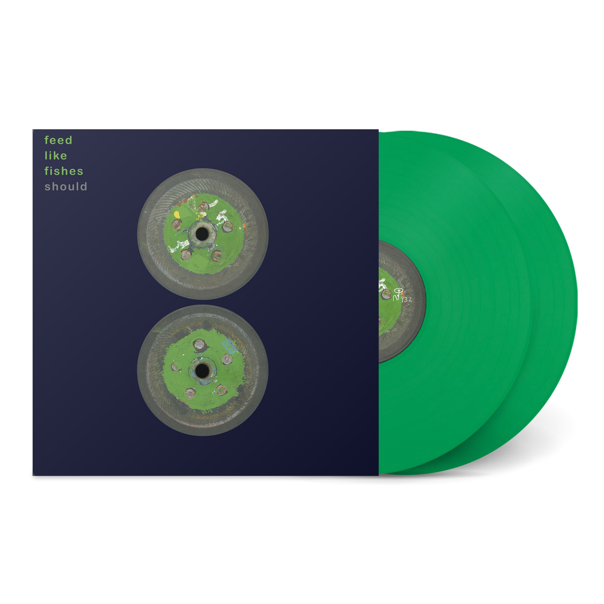 Feed Like Fishes vinyl album with green records and cover art featuring two circular images on a dark background.