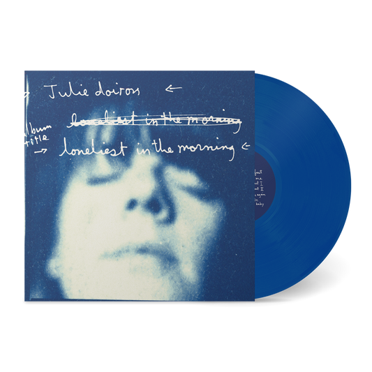 Blue vinyl record partially visible next to an artistic blurred face on the cover with handwritten text "Loneliest In The Morning