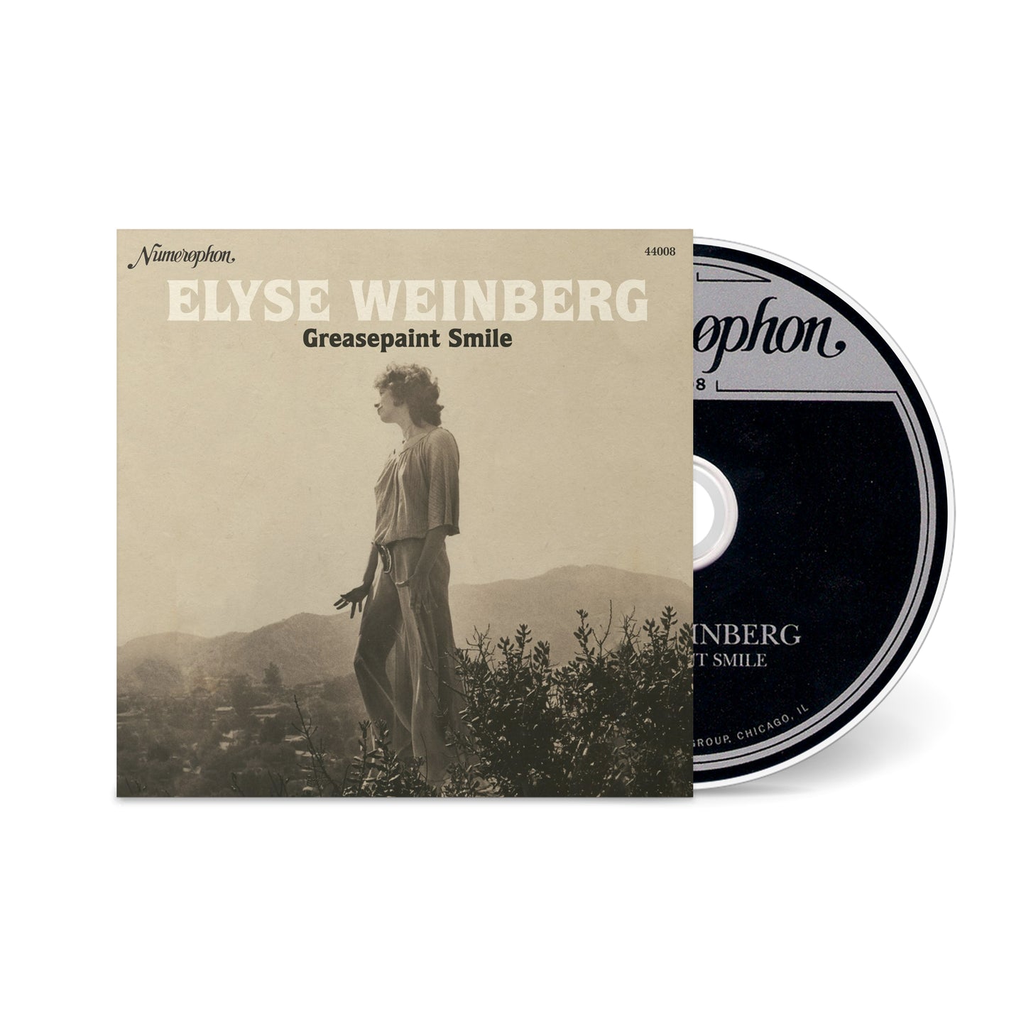 Greasepaint Smile album cover with a sepia photo of a woman standing overlooking a landscape and the CD partially visible