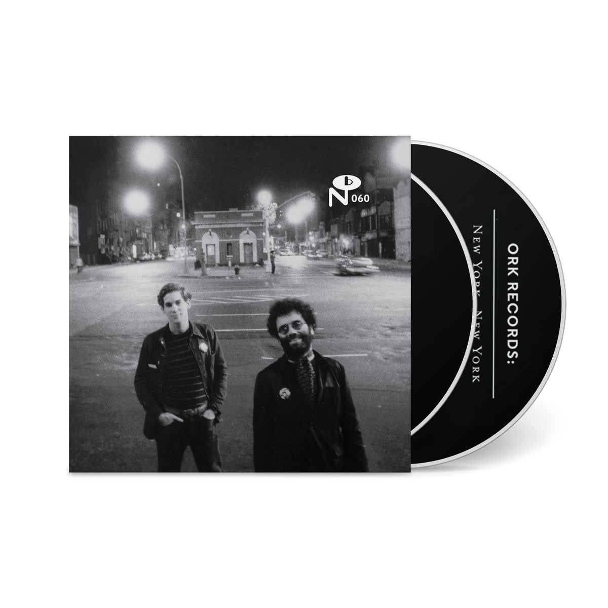 Black and white photo of two men on a city street at night with a CD partially visible titled New York, New York