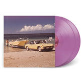 Vintage car towing a boat on the beach next to two purple vinyl records of Private Yacht.