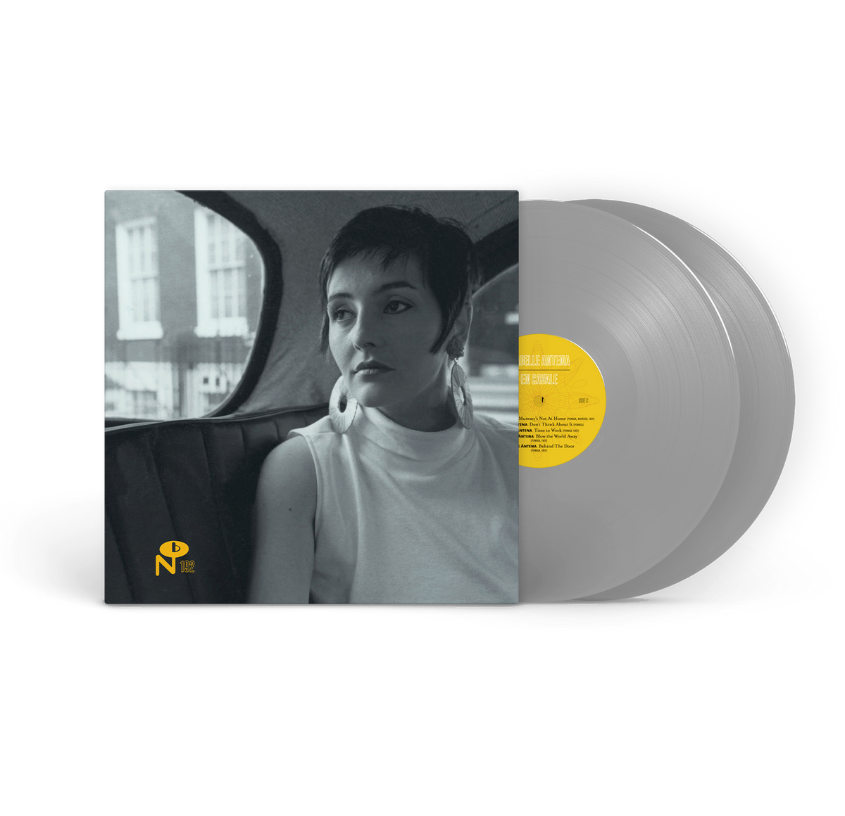 En Cavale album cover with black and white photo of woman and silver vinyl record with yellow label
