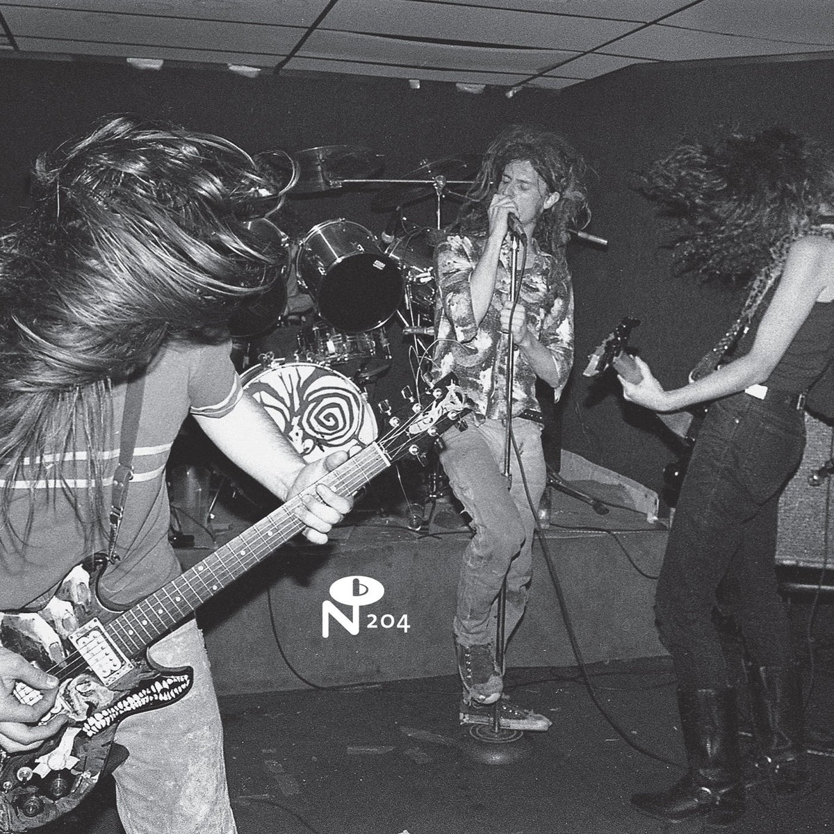 Black and white photo of a band performing live with intense energy for It Came From N.Y.C. rare records compilation