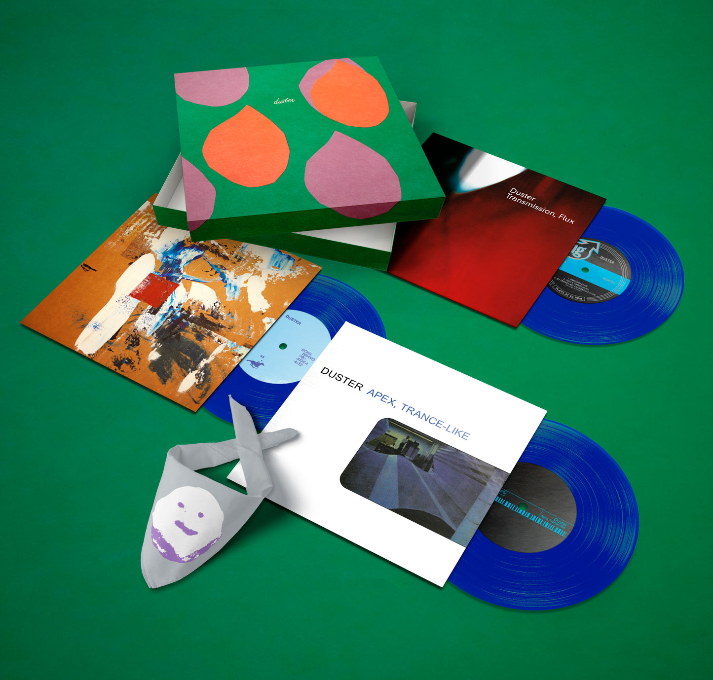 Blue transparent vinyl records with colorful album covers and a folded cloth on green surface, featuring Moods, Modes.