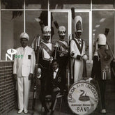 Black and white vintage photo of a marching band from Florida A&M University with The Deep City Label logo.
