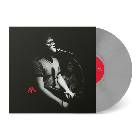 Black and white image of a man singing into a microphone on the vinyl album I Just Want To Talk To You