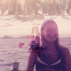 Soft-focused image of a smiling woman by water and palm trees with Lady Full Of Dreams text and vintage vibe