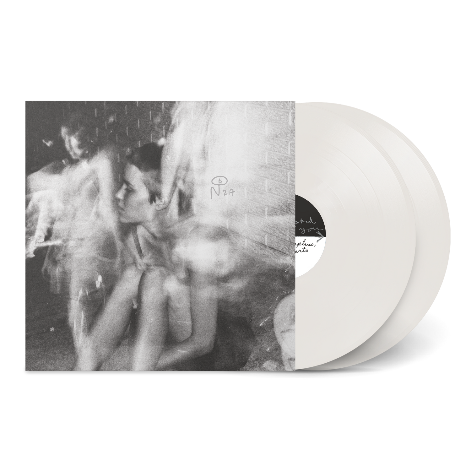 Paper Airplanes, Paper Hearts vinyl record with black and white blurred photo of a seated person and two white discs
