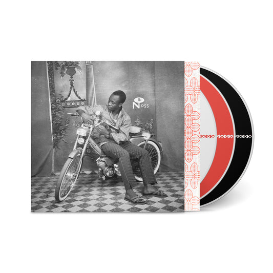 Vintage black and white photo of a man on a motorcycle with Belle Époque in Upper Volta vinyl record set.