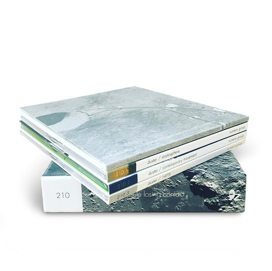 Stack of Capsule Losing Contact CDs and book with minimalist space-themed cover art by Numero Group