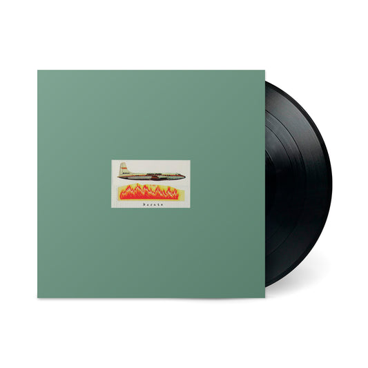 Karate album cover with vintage airplane graphic and vinyl record partially visible beside green sleeve