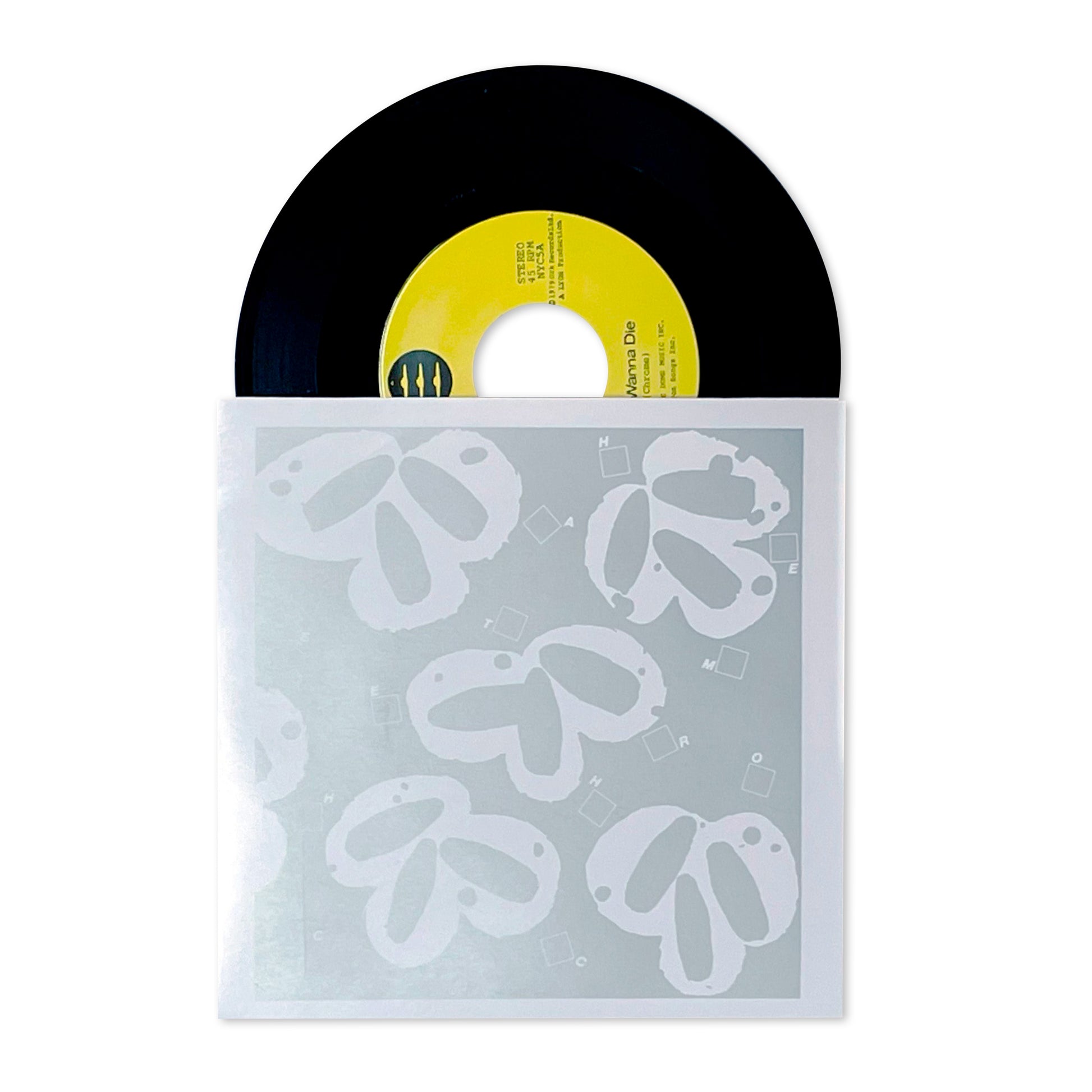 Still Wanna Die b/w Take Me Home vinyl record with yellow label partially slid out of translucent sleeve with white floral design