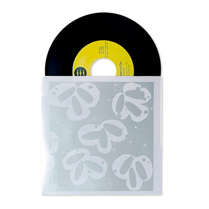 Still Wanna Die b/w Take Me Home vinyl record with yellow label partially slid out of translucent sleeve with white floral design