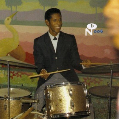 Man playing drums in colorful retro setting for Belize City Boil Up album cover by Numero Group